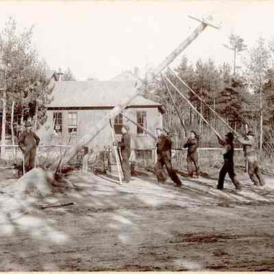 Workers Putting Up Electrical Lines