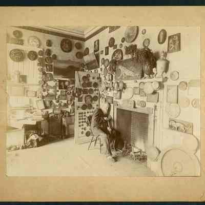 Old Man in Room with Plaques