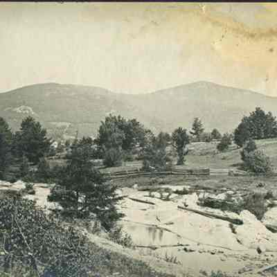 Clearing with Stream and Fence