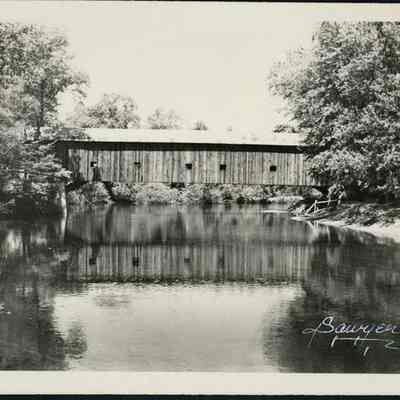 Side View of Covered Bridge Over Slow Flowing River