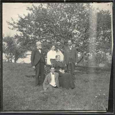 Posing in a Field with Trees in the Background