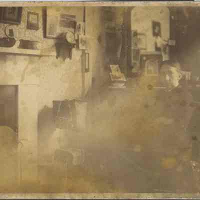 Woman Sitting by Fireplace