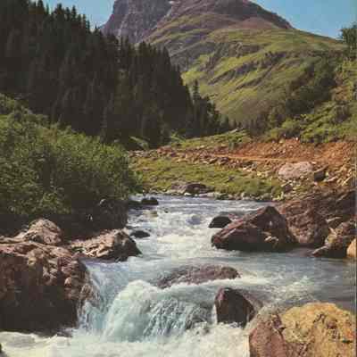 Small Cascade in Front of Mountain