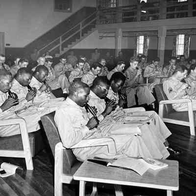c1940 photograph of Edgar Zobel instructing soldiers on how to play the tonette on an Army base, probably California. (Edgar not shown in photo.)