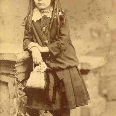 Coe_Caroline_002: Portrait of Caroline Coe as a little girl holding purse, photographed by S.B. Hill