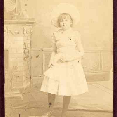 Coe_Caroline_003: Portrait of Caroline Coe as a little girl standing on book, photographed by S.B. Hill