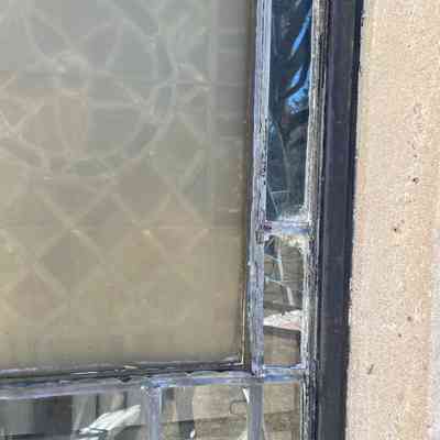 Broken glass as seen from outside, March 2025