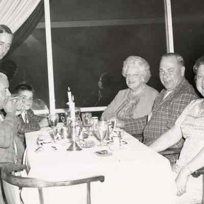 Coe_Family_036: Coe extended family members seated at dinner