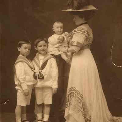 Coe_Family_039: Portrait of Mai Coe holding Henry H.R. Coe, alongside William Rogers Coe and Robert D. Coe