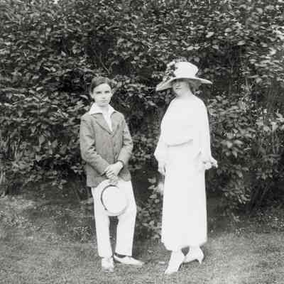 Coe_Family_041: Mai Coe and Henry H.R. Coe in front of bush