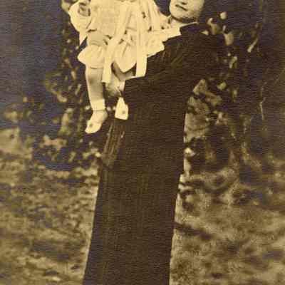 Coe_Family_045: Mai Coe holding Natalie Coe wearing baby bonnet