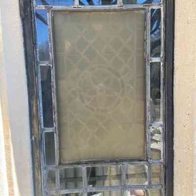 Window from outside, showing condition of lead as well as severely yellowed plexiglass barrier, March 2025