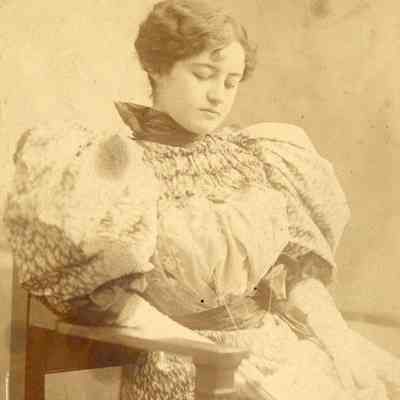 Coe_MC_002: Portrait of Mai Coe as a young woman wearing puffed sleeves, photographed by Aime Dupont