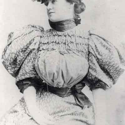 Coe_MC_004: Portrait of Mai Coe as a young woman wearing hat and puffled sleeves