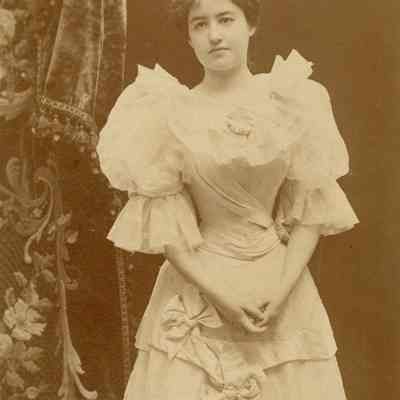 Coe_MC_006: Portrait of Mai Coe with hands linked in front of torso, photographed by H.E. Mendelssohn