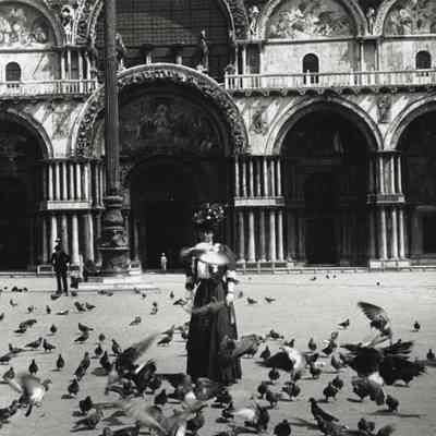 Coe_MC_008: Mai Coe with pigeons at St. Mark's Square, Venice