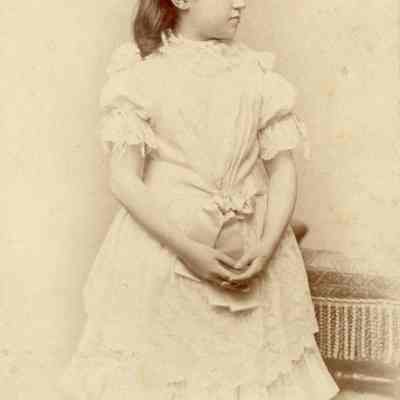 Coe_MC_015: Portrait of Mai Coe as a child with hands interlocked, photographed by Hargrave & Gubelman