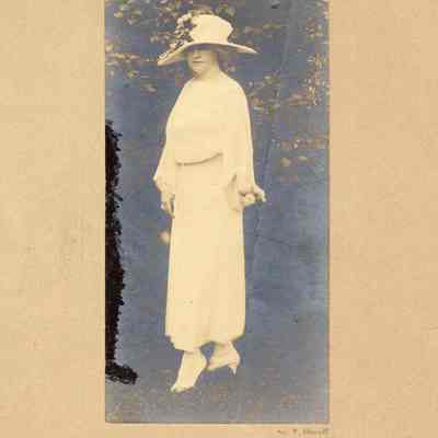 Coe_MC_018: Portrait of Mai Coe as an adult wearing white dress and hat, photographed by Mattie Edwards Hewitt