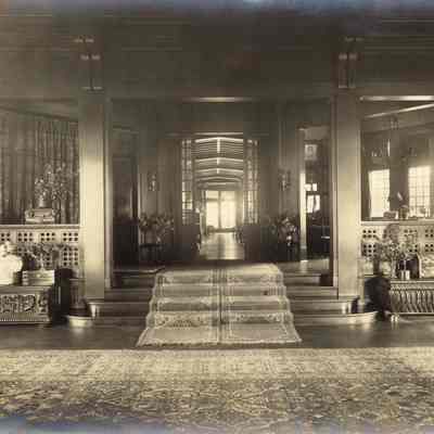 Byrne_006: Interior of Great Hall looking towards steps with runner rugs