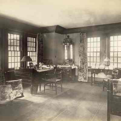Byrne_028: Interior of another bedroom with bed (left) and desk (right), photographed by August Patzig