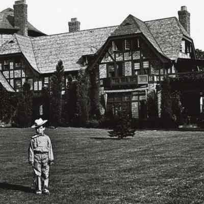 Byrne_046: Little boy standing outside of Byrne House
