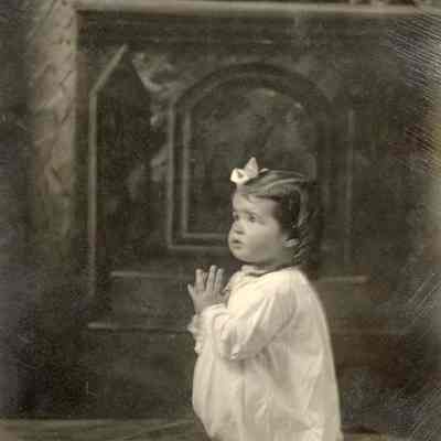 Coe_Natalie_017: Portrait of Natalie Coe with palms together; "AMEN" written at bottom of photo