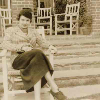 Coe_Natalie_034: Natalie Coe sitting in chair in front of steps