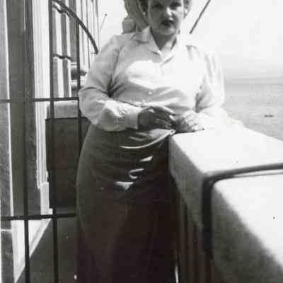 Coe_Natalie_039: Natalie Coe standing by balcony ledge