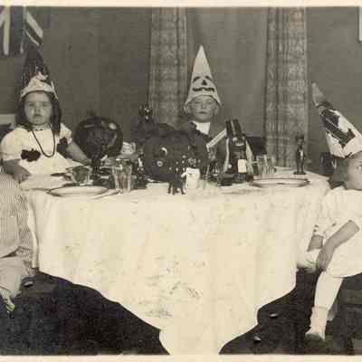 Coe_Natalie_053: Natalie Coe with other children at Halloween party; "Having company" written on back