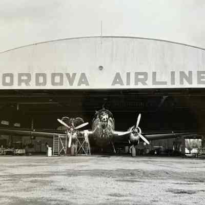 Cordova Airlines Hangar with Aircraft Photograph: Cordova Airlines Hangar - Doors Open with Aircraft inside. Black and White photograph by Bernard A. Robar Negative no. 600708BA