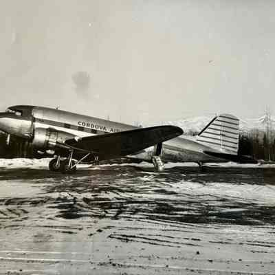 Cordova Airlines Aircraft Photograph - N25669: Black and White photograph of the Cordova Airlines N25669. Mountain and snow in the background. Photograph by Bernard A. Robar Negative No. 630313B