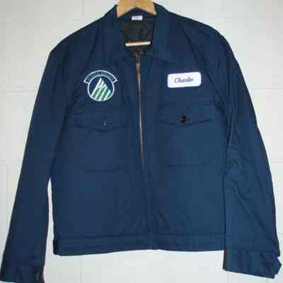 Dark blue mechanics jacket with mountain logo on right chest and "Charlie" on left chest.