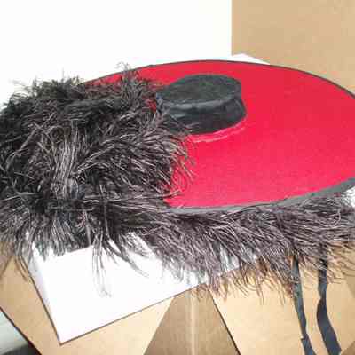 Large red hat with feathers. 
1966
Condition good.
Location: Museum of Flight