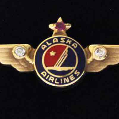 Alaska Airlines 25-year Service Pin - Gold Wings with a ruby set in a star, two diamonds collet in wings