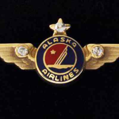Alaska Airlines 30-year Service Pin - Gold Wings with a diamond set in a star, two diamonds collet in wings
