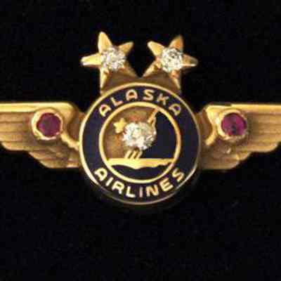 Alaska Airlines 35-year Service Pin - Gold Wings with two diamonds set in the stars, two rubies collet in wings and one large diamond, center