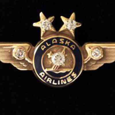 Alaska Airlines 40-year Service Pin - Gold Wings with two diamonds set in the stars, two diamonds collet in wings and one large diamond, center