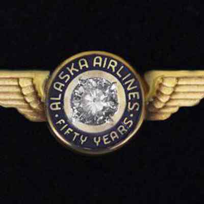 Alaska Airlines 50-year Service Pin - Gold Wings with one-third-carat diamond in the center, circled with "Alaska Airlines Fifty Years"