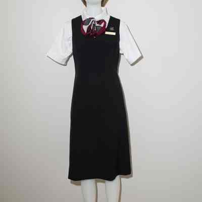 V-neck black jumper (also in red) with black and cranberry scarf, white short sleeved shirt.
Scarf can be change by tying it differently.