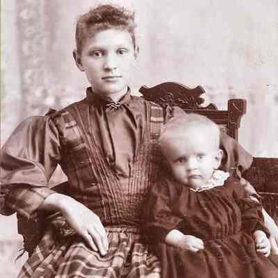 seated girl with toddler, unidentified