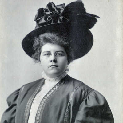 woman in a hat and wearing glasses, unidentified