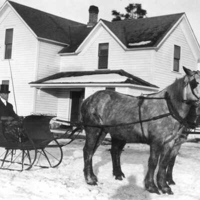 Fred Campbell circa 1900 in cutter rig pulled by 2 horses. Location unknown, perhaps the family farm?