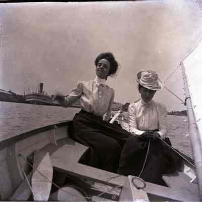 Two women sailing in harbor