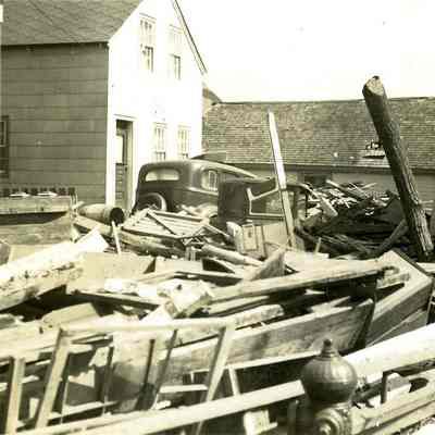 People standing outside houses surrounded by debris