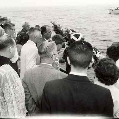 Boat with people and floral memorial wreath