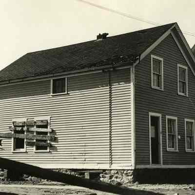 Damaged house with boarded up windows