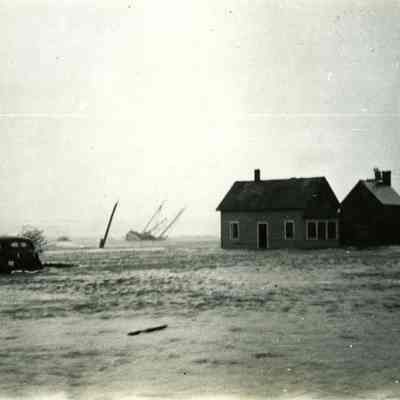 Houses and cars on flooded street, Stonington Harbor side
