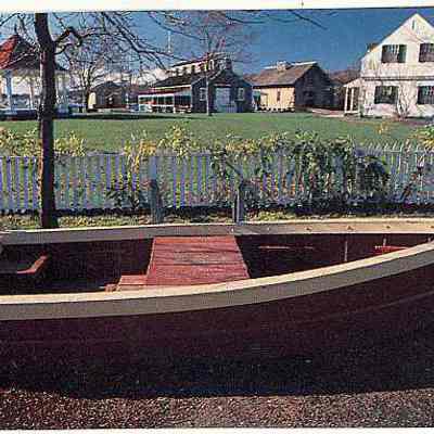 Small picture of boat in front of houses