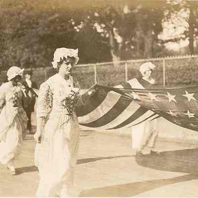 Stonington girls carrying American flag during parade, Water Street, Stonington CT