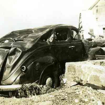 Destroyed car among debris